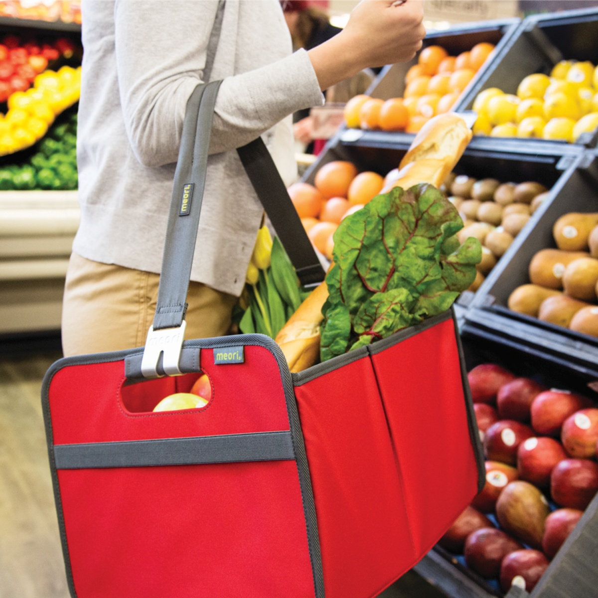 Woman holding rectangular storage basket filled with groceries with Carrying Handle