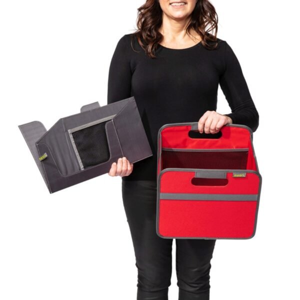 Woman holding small red storage cube and magazine insert