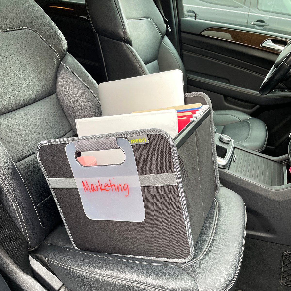 A100094-22-meori-Hanging-File-Box-Lava-Black-LST Black Hanging File Box with file folders on the passenger seat of a car