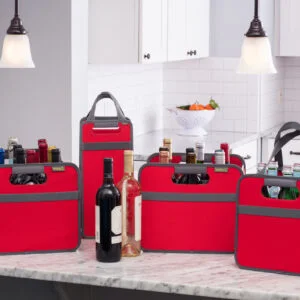 Group photo of various red Bottle Wine Totes filled with variety of bottles sitting on a kitchen counter