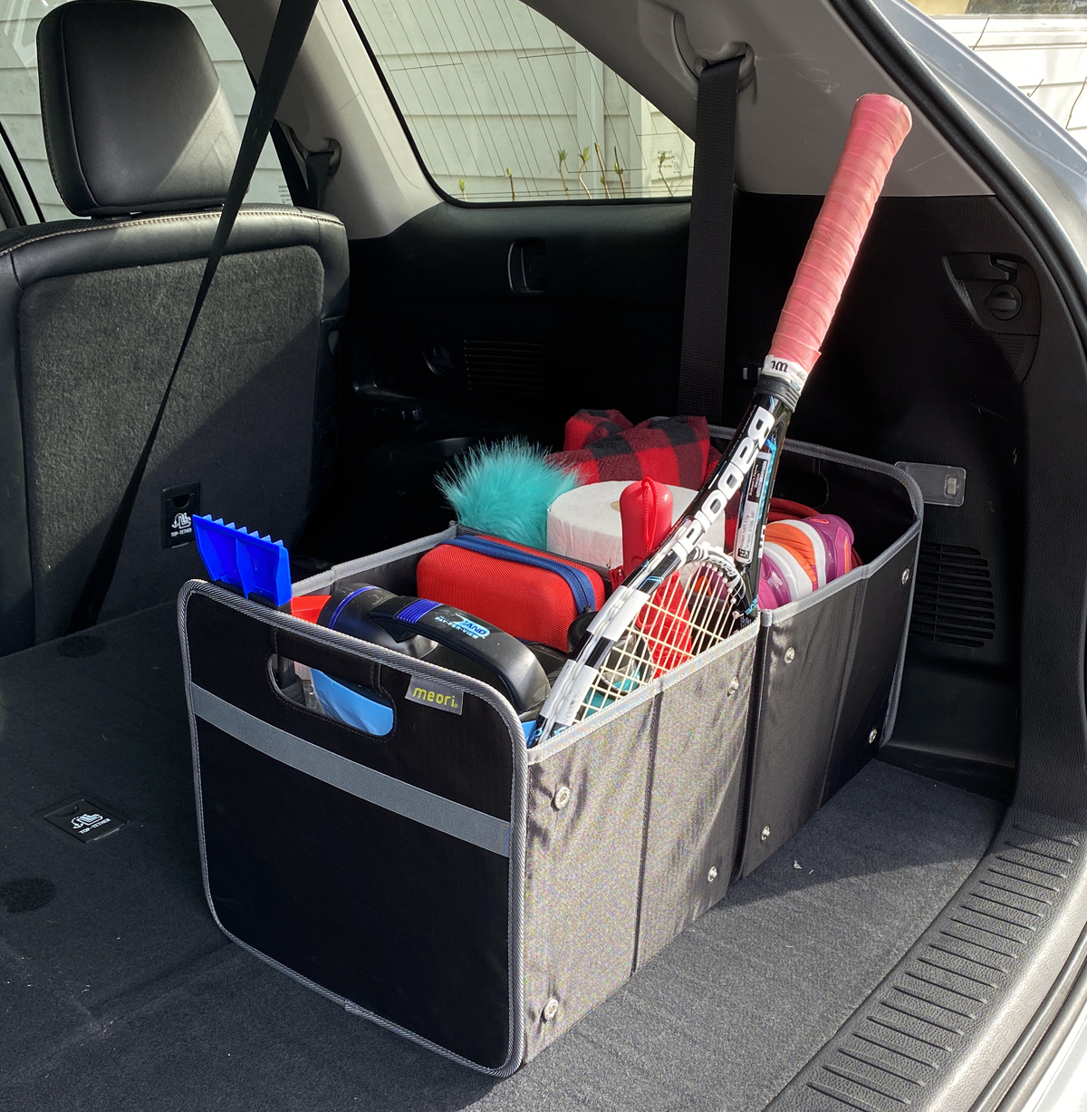 A100501-17-meori-XL-Foldable-Box-Lava-Black-LST Black Extra Large Storage Bin filled with variety of car and athletic gear in the trunk of a car