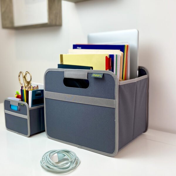 Grey Mini Storage Box next to grey Storage Cube filled with files and office supply on desk