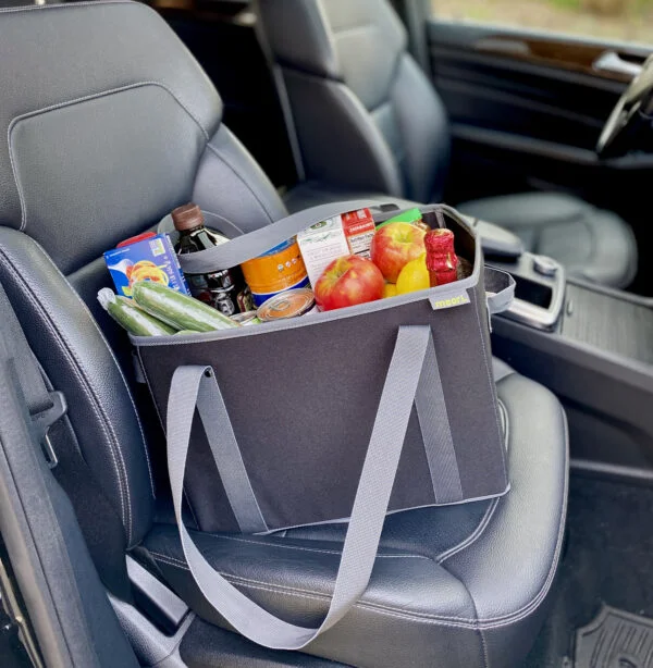 Black Collapsible Shopping Basket filled with groceries on passenger-side car seat