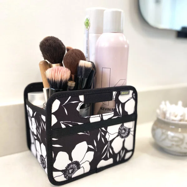 Black Small Storage Cube with White Floral Print with cosmetics on bathroom counter