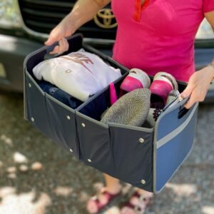 Woman carrying Marine Blue Extra Large Storage Bin filled with clothing items