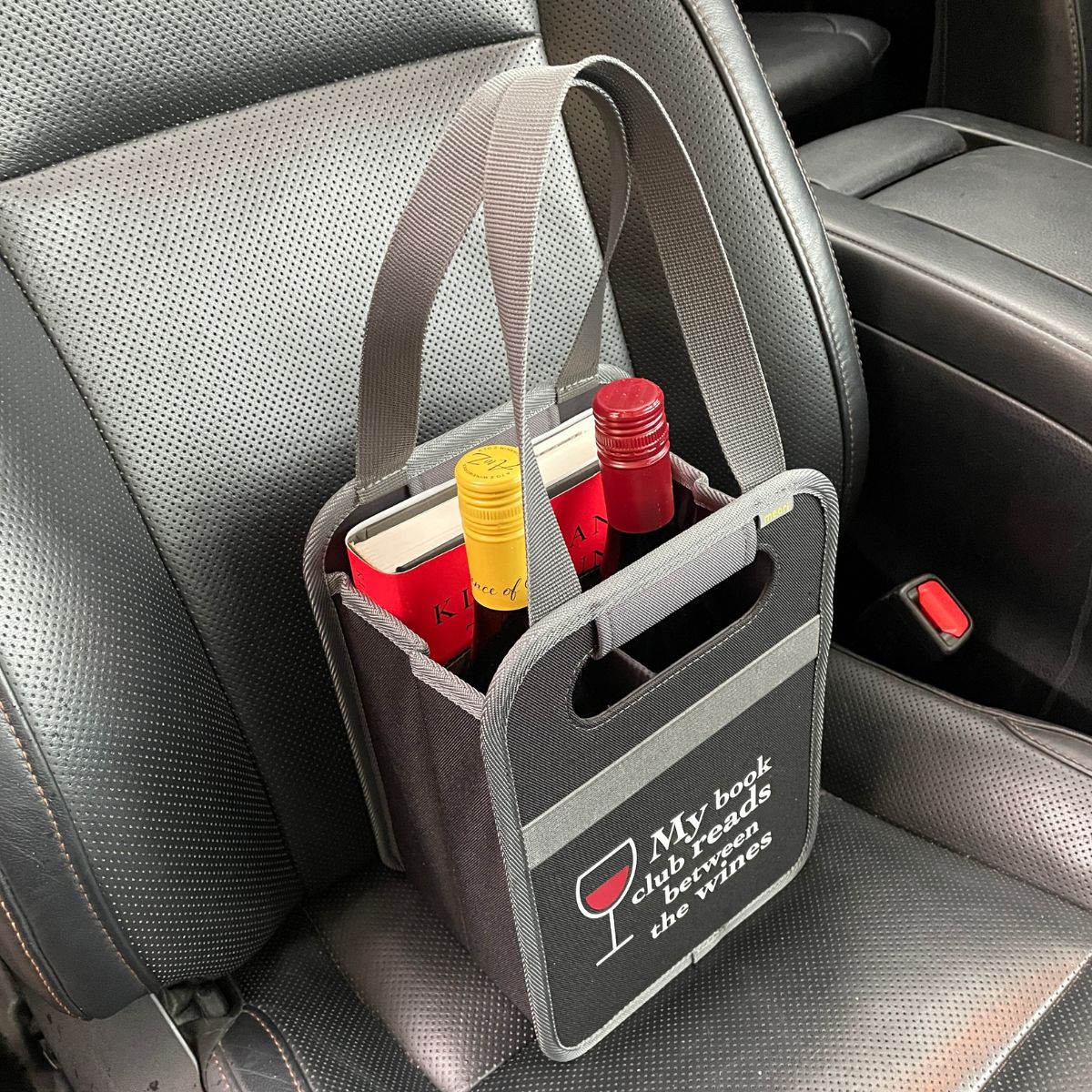 A100873-08-meori-Book-Club-Wine-Tote-LST Black Book Tote Bag with two bottles and a book on passenger-side car seat