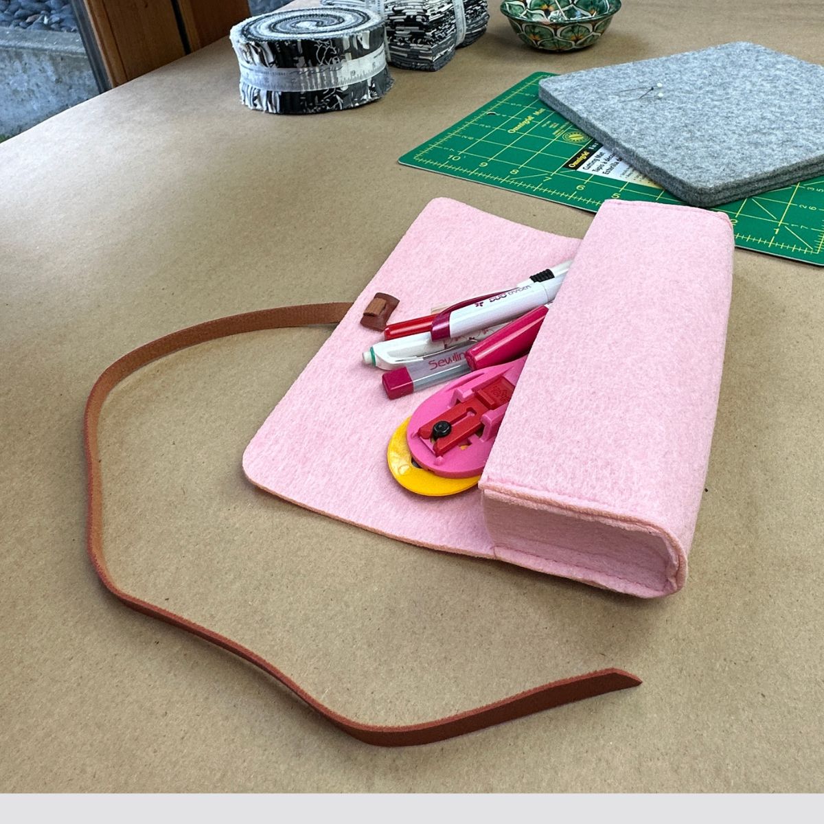 Rose-colored Pencil Case Pouch with quilting accessories on craft table