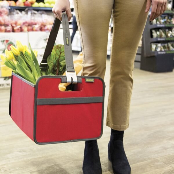 Woman carrying a Red Farmers Market Tote filled with flowers and veggies