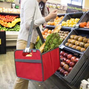 Woman standing in front of fruit section with Red Farmers Market Tote hanging over her arm