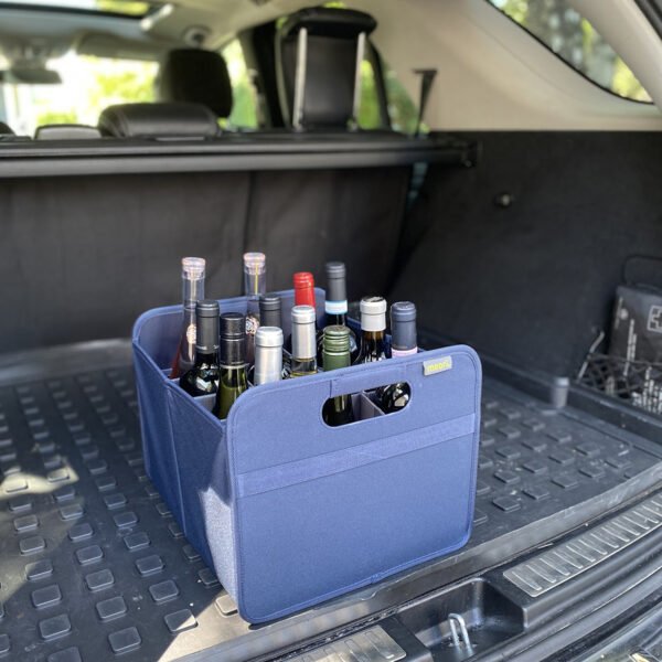 Marine Blue 12 Bottle Wine Carry Bag filled with bottles in the back of a trunk