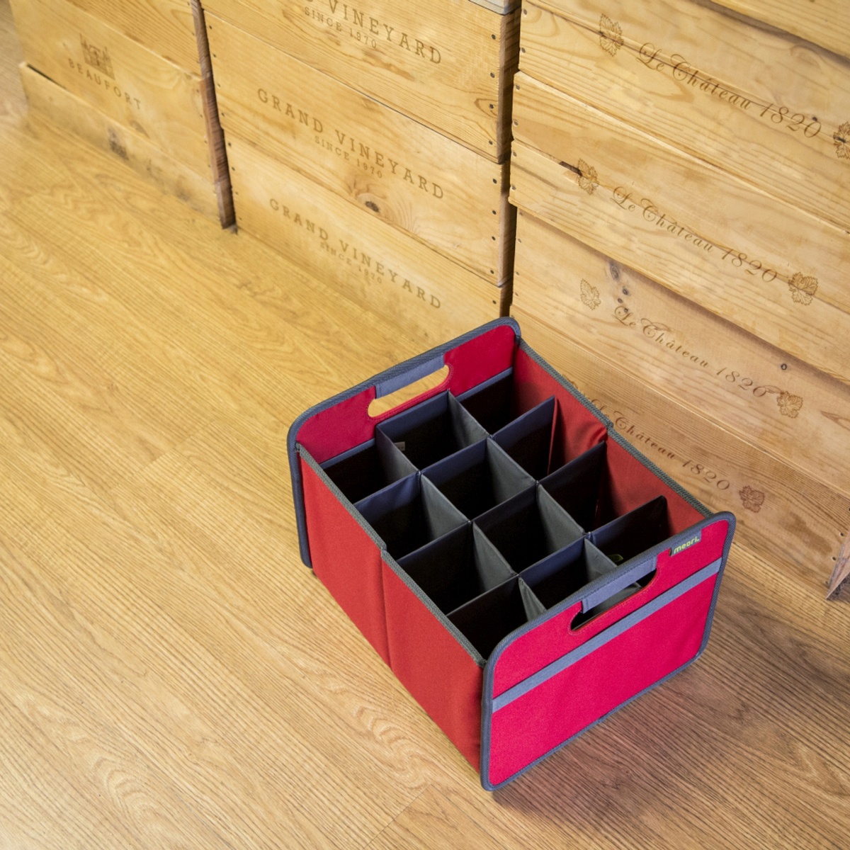 B100296-09-meori-12-Bottle-Wine-Carrier-Hibiscus-Red-LST Empty Red 12 Bottle Wine Carry Bag sitting on the floor in front of wine crates