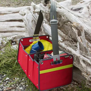 Red Trunk Organizer with camping supplies hanging on tree stump