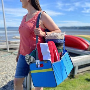 Woman carrying Blue Trunk Organizer with beach supplies over her shoulder