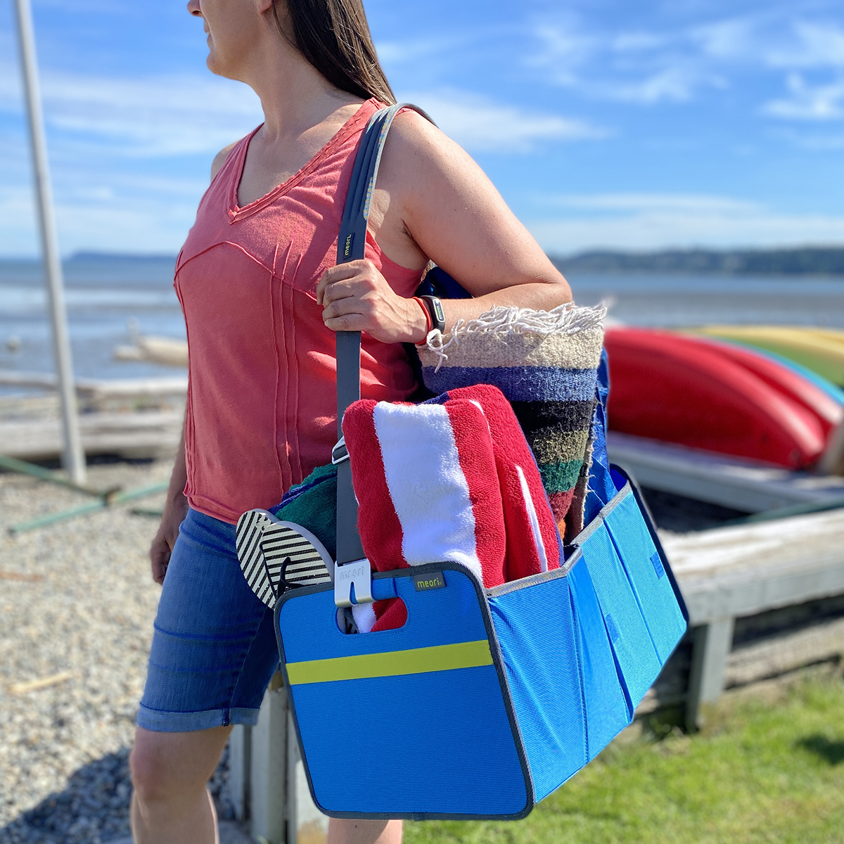 Woman carrying Blue Trunk Organizer with beach supplies over her shoulder