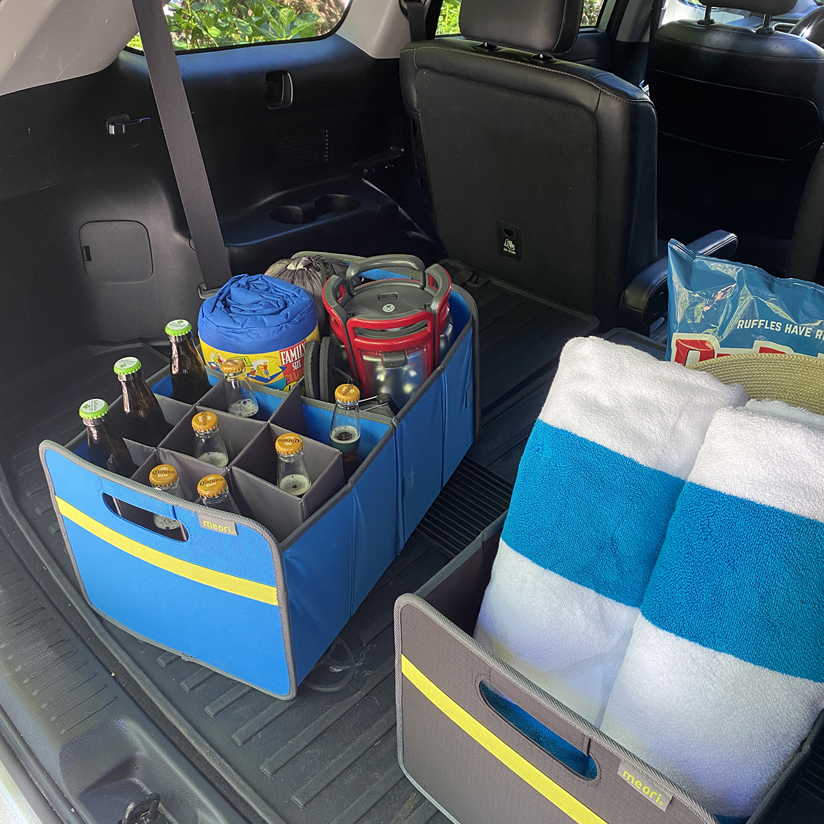 B100844-09-meori-Premium-Box-with-Bottle-Insert-Med-Blue-LST Blue Car Trunk Organizer with 9 bottles and camping gear in the back of a trunk