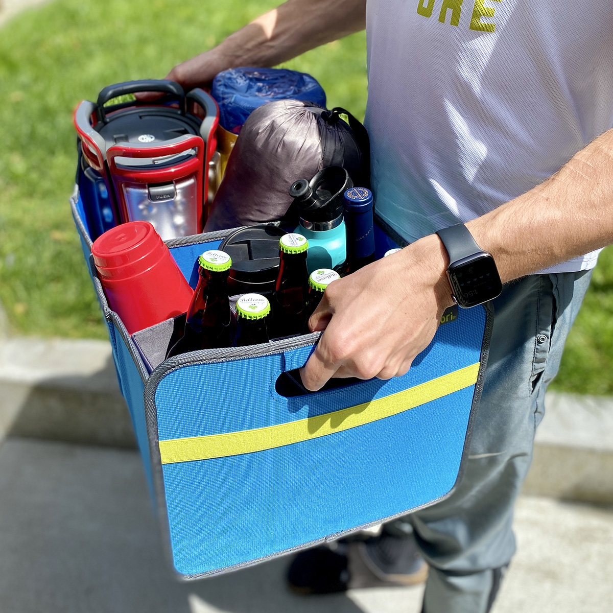 B100844-15-meori-Premium-Box-with-Bottle-Insert-Med-Blue-LST Man carrying Blue Car Trunk Organizer with 9 bottles and camping gear